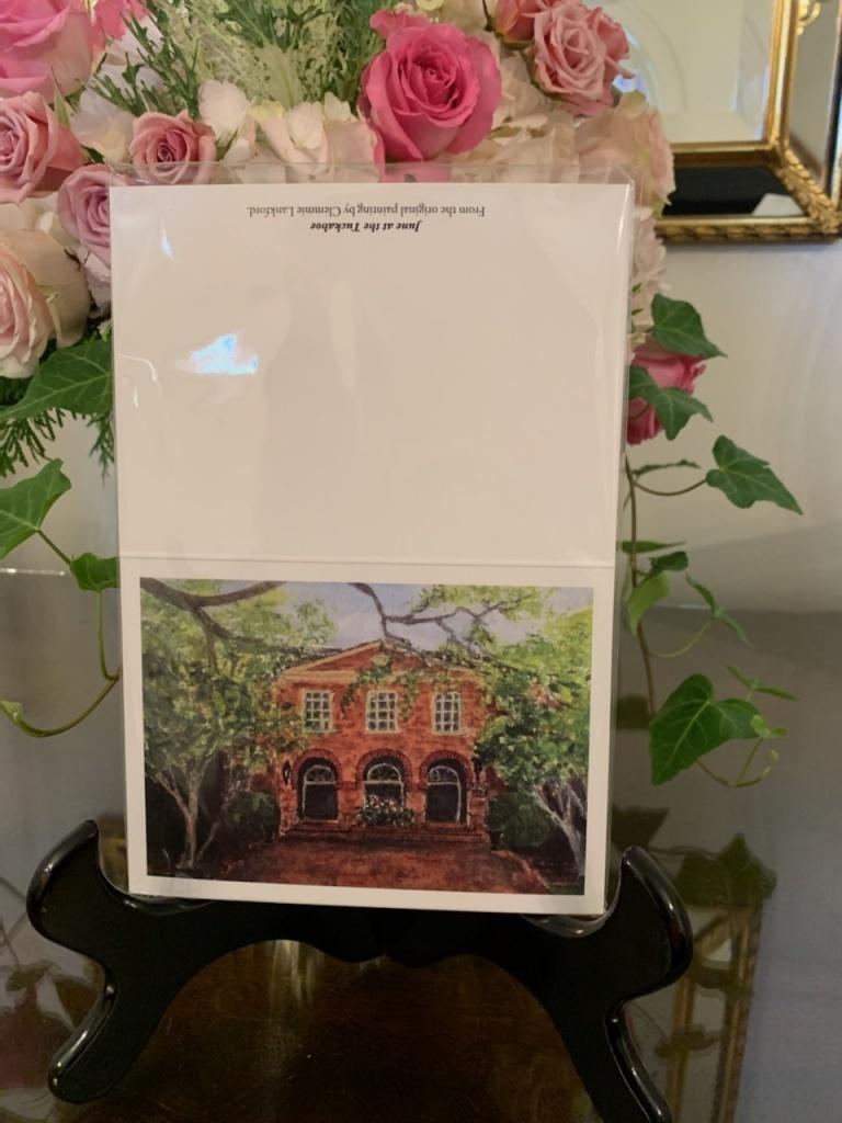 Note cards with a painting  of a brown brick building on them. 
